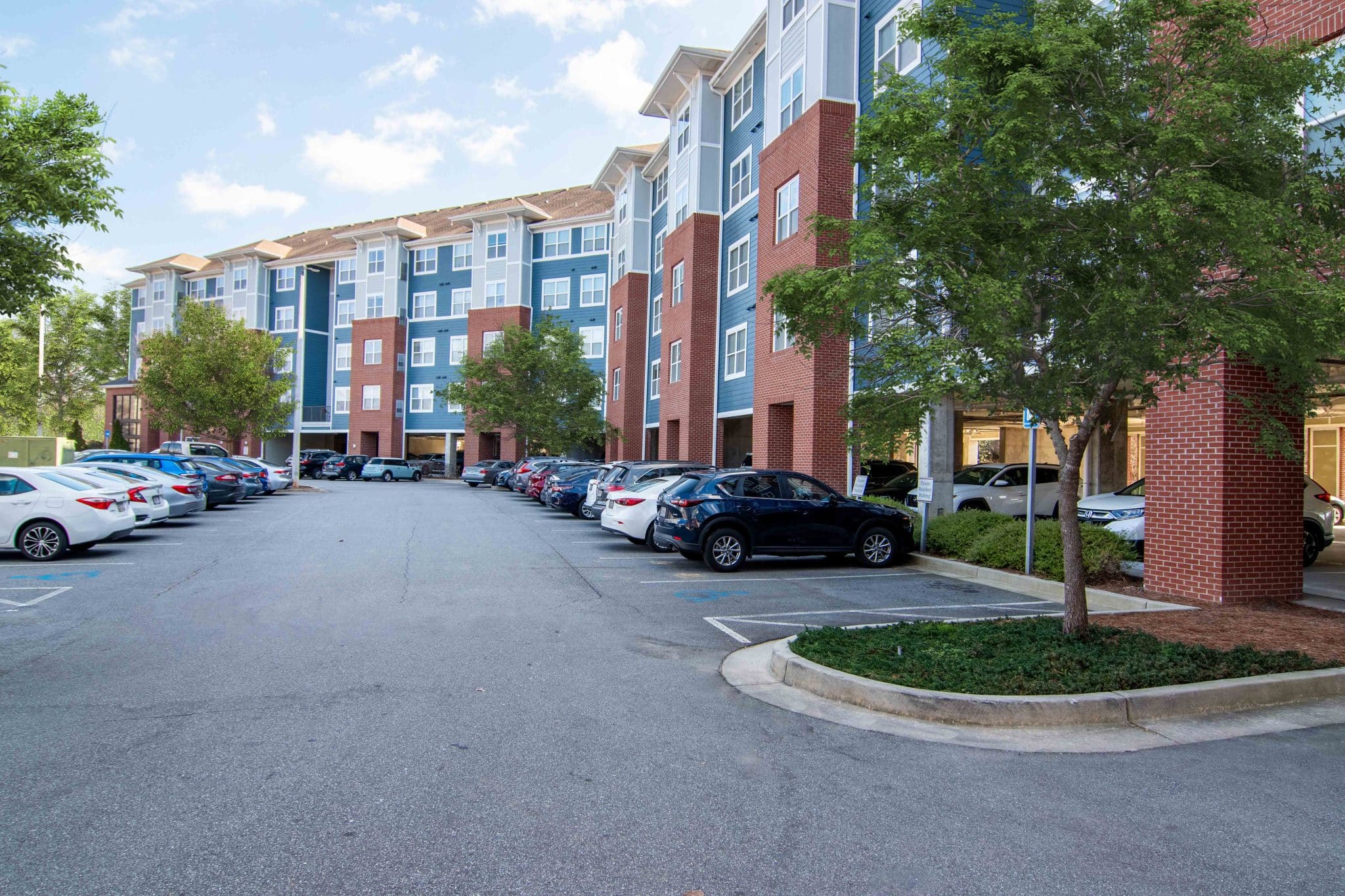 the flats at carrs hill apartments near uga community building exterior resident parking